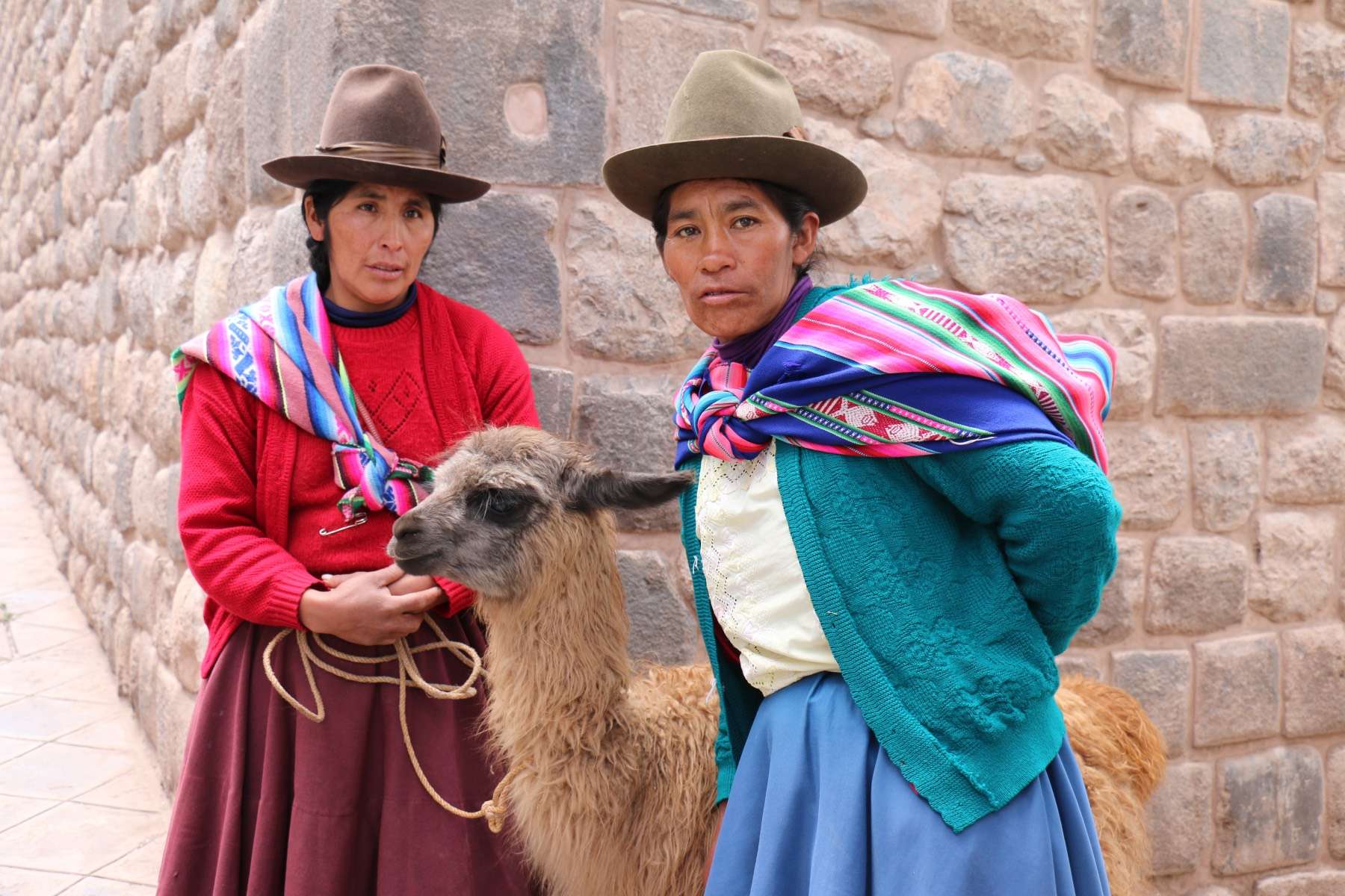 Two indigenous women with an Alpaca in Cusco Peru