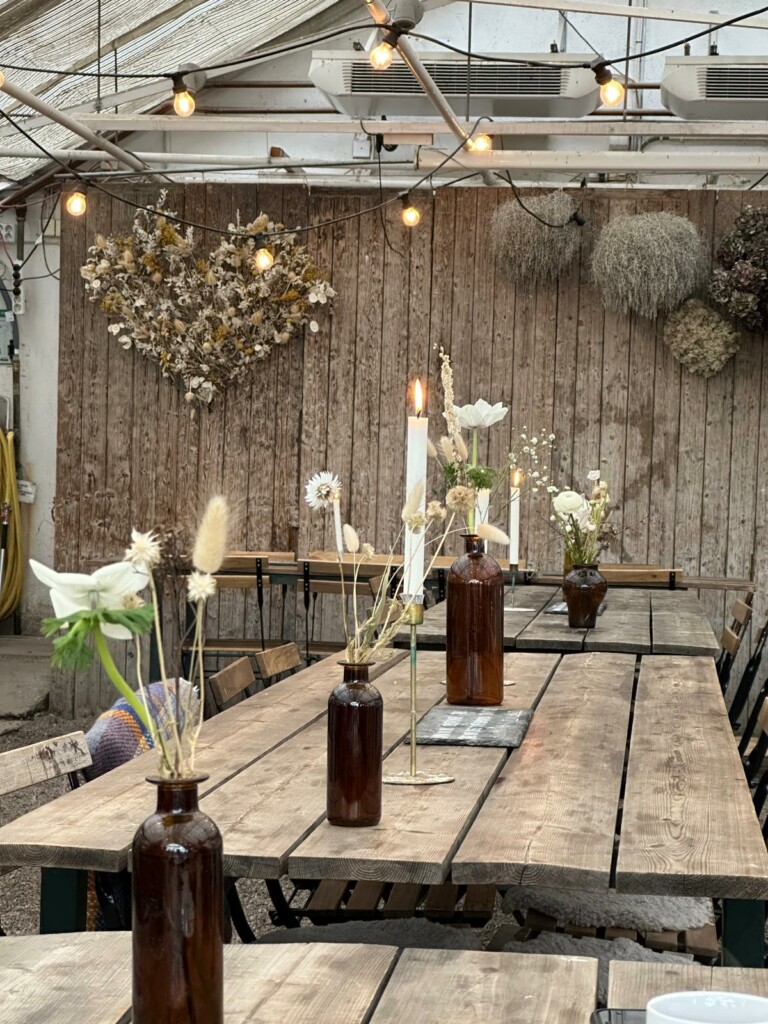 Tables inside the greenhouse in Rosendals trädgård
